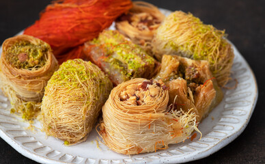 Traditional turkish, arabic sweets baklava assortment with pistachio and knafe (Kunefe, kunafa, kadayif)