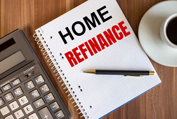 HOME REFINANCE written in a white notepad near a calculator and a cup of coffee on a dark wooden background