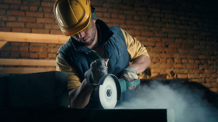 Adult man cutting brick wall
