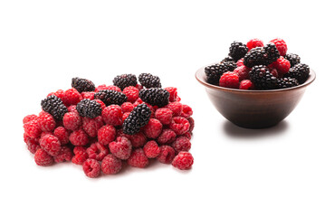 Raspberry, blackberry and mint leaf in ceramic brown bowl isolated on white