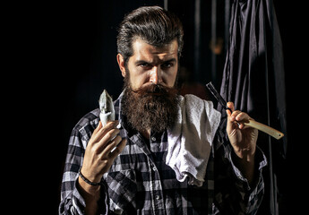 Bearded man in barbershop. Barber scissors and straight razor, barber shop. Vintage barber shop,...