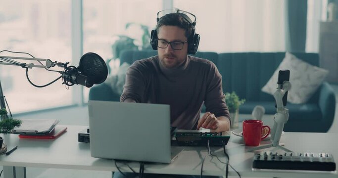 Caucasian Radio Host Bearded Man Recording Online Podcast Video Chatting with Social media Audience Talking on Mobile Phone Camera with Followers.