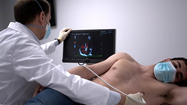 Doctor examining heart of patient with ultrasound equipment