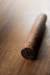 Brown cuban cigar on wooden background