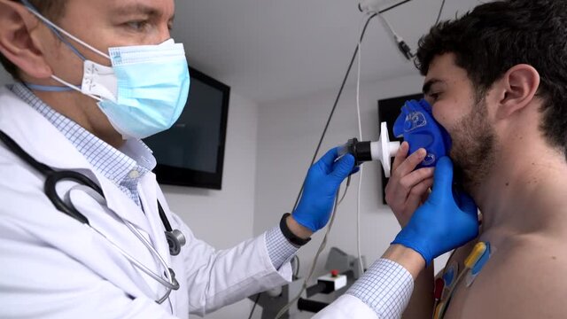 Doctor preparing patient for cardiac stress test in clinic