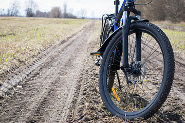 front wheel of a mountain bike. Mountain bike. stands on a field road. concept of cycling, repair...