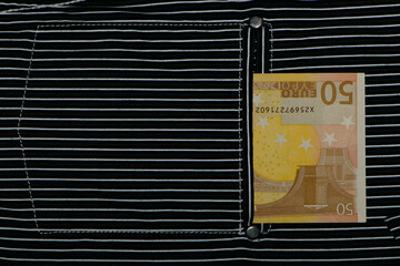 money in your pocket. Banknote 50 euros. pocket of striped shirt and European money in it. cash payments, seasonal discounts and financial concepts. paper money, currency, euro, close-up, angle view