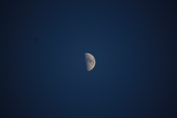 Brightly shining moon in a cloudless night sky