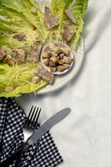 Homemade Caesar Salad with romanine, cheese, croutons, chicken, lemon and sauce