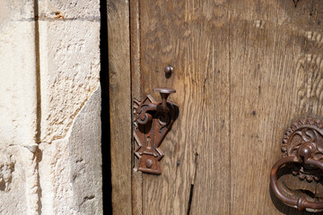 Door lock and door knocker on old doors photographed in daylight