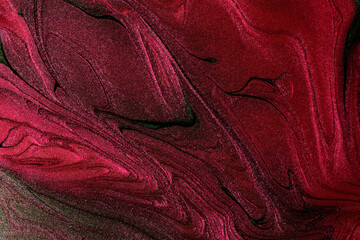 Beautiful surface of the red metallic texture with green stripes.Abstract nail polish background,fluid art technique.Horizontal photography,good as digital decor.Flow modern backdrop.