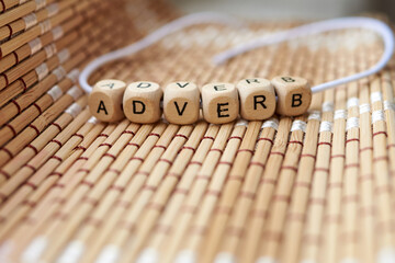 Word adverb lined with wooden cubes