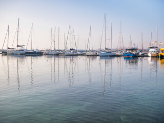 Fototapeta na wymiar Many boats and yachts anchored at the touristic port or harbor in Mangalia, Constanta