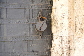 Door lock and door knocker on old doors photographed in daylight