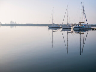 Fototapeta na wymiar Many boats and yachts anchored at the touristic port or harbor in Mangalia, Constanta