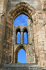 blue sky behind arches of castle ruins