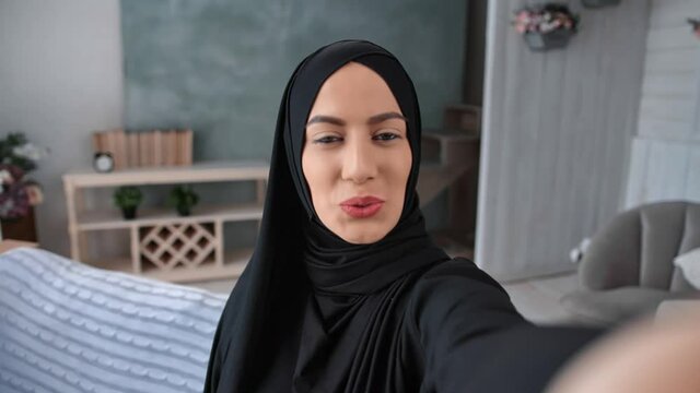 Closeup face Muslim woman face posing photographing at home interior POV shot. 4k Dragon RED camera