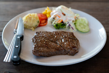 Grilled beef steak on the white plate