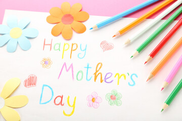 Text Happy Mother's Day with colorful pencils and paper flowers on pink background