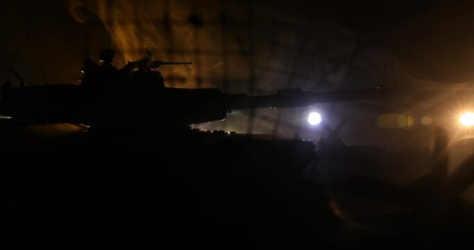 War Concept. Armored vehicle silhouette fighting scene on war foggy sky background at night. American tank moving in destroyed city. Slider shot