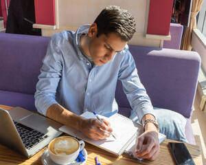 young businessman ponders a solution while completing a biology project