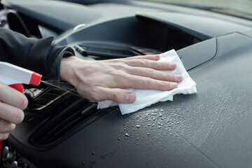 Man hands cleaning dirty vehicles interior uses wet rag, spray water. Wet car cleaning inside. Spring dry automobile.