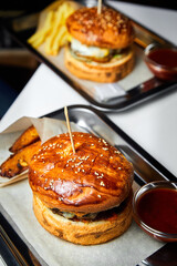Fast food hamburger and french fries on a metal plate