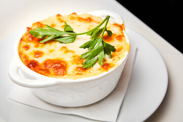 Baked chicken fillet with potatoes and cream cheese sauce. Close-up, selective focus