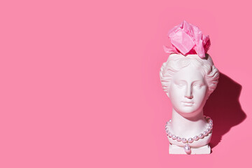 Trendy Venus plaster head planter with paper brain on pink background