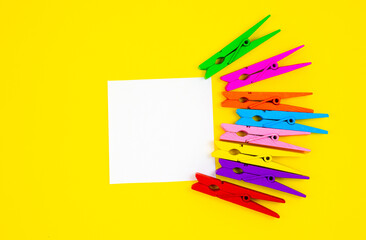Colorful wooden clothespins with To Do List Sticker on yellow background. Close up, copy space. Minimalism, original and creative photo.