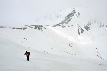 Group of alpinists trekking in harsh winter conditions