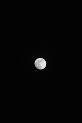 Brightly shining moon in a cloudless night sky