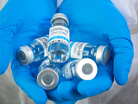 Doctor Holds Many Covid-19 Vaccines In The Palm Of His Hands. Vials Of SARS-CoV-2 Vaccines, Coronavirus Vaccination Concept. Giving Vaccine Bottles.