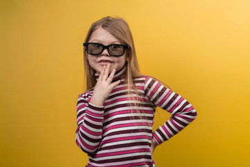 Children's cinema concept. White girl in 3D glasses with different emotions on a yellow background.