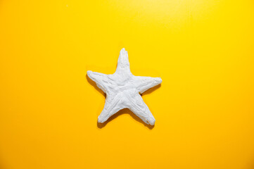 Fototapeta na wymiar Plaster starfish on yellow background.