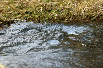 A bubbling river with a small waterfall