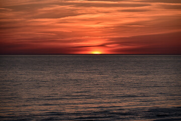 Fototapeta premium sunset at sea with a calm water surface