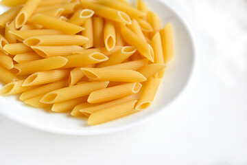 Yellow delicious pasta close-up on a white plate