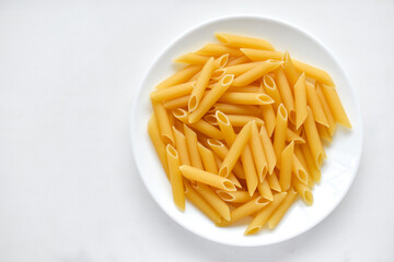 Yellow delicious pasta close-up on a white plate