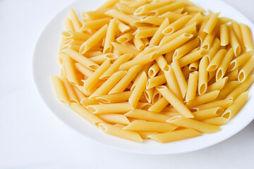 Yellow delicious pasta close-up on a white plate