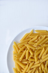 Yellow delicious pasta close-up on a white plate