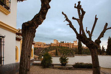 View of the Alhambra palace complex across the Darro valley from Placeta Comino, El Albaicín, Granada, Andalusia, Spain