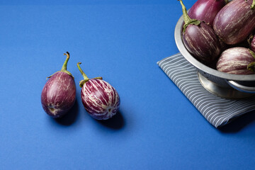 striped eggplant on a blue background. Healthy food concept.