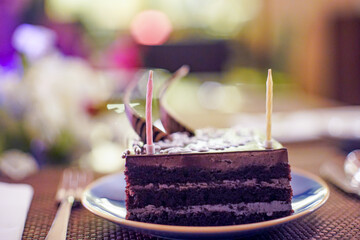 shot of cake with sparkling candles with flames and sparks flying out with an out of focus...