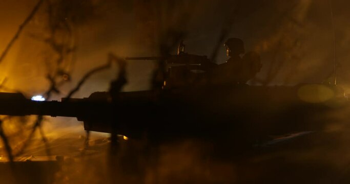 War Concept. Armored vehicle silhouette fighting scene on war foggy sky background at night. American tank moving in destroyed city. Slider shot