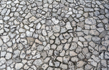 Detailed close up on old vintage cobblestone roads and walkways placed on a floor inside of Wawel castle in Krakow, Poland, Europe. Abstract stone rock pattern texture background