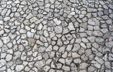 Fototapeten Detailed close up on old vintage cobblestone roads and walkways placed on a floor inside of Wawel castle in Krakow, Poland, Europe. Abstract stone rock pattern texture background © Arpan