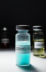 medical ampoule with blue liquid and the inscription Covid 10