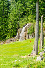 Fototapeta na wymiar Golf course with gorgeous green and waterfall.
