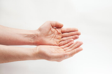 Fototapeta premium Hands of a man with open palms on a light background, hands as if holding something, a blank for advertising something. Mockup